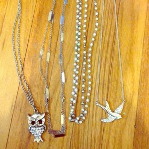 Set of four silver necklaces.