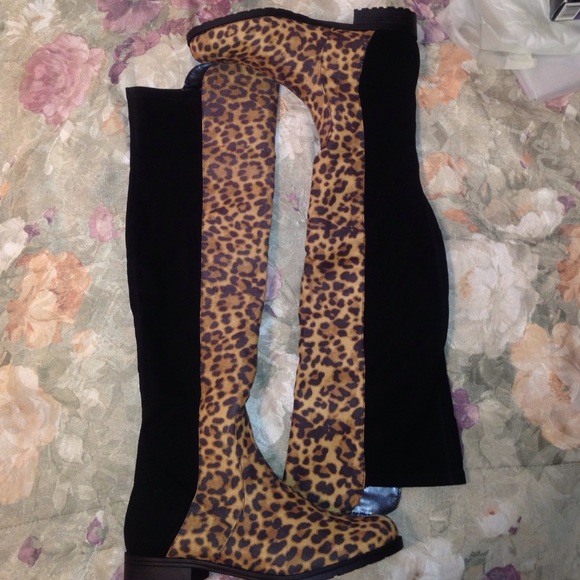 Over the knee animal print and black suede boots.