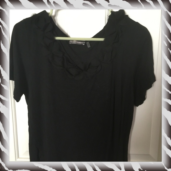 Black top with Ruffles around neckline.