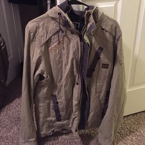 A tan lightly worn G-star coat. Size Large