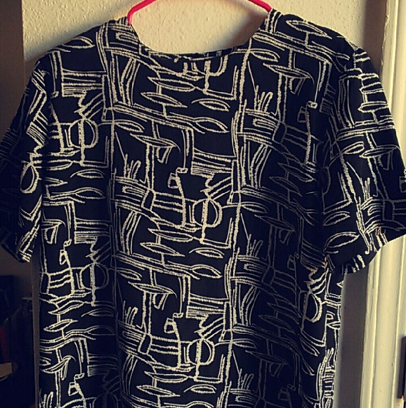 Black t-shirt blouse with white geometric pattern.