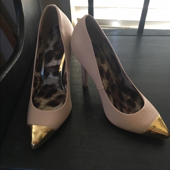 Nude pumps with gold toe accent.