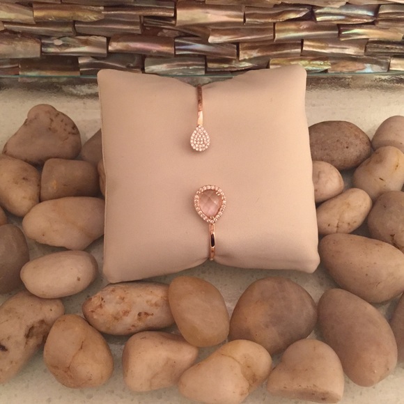 Rose gold bangle with pink teardrop stone.