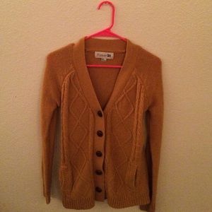 a mustard color sweater/cardigan