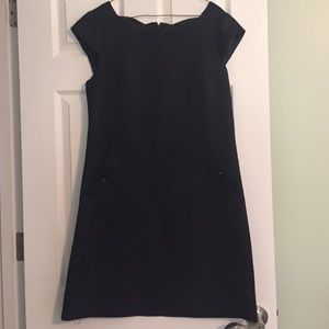 A symmetrical black dress