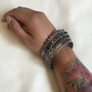 Jeweled bangle set in brandish silver.