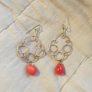 Gold swirly wire earrings with orange dangle bead
