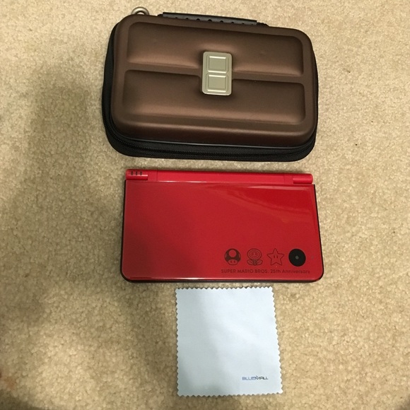 Nintendo DSi XL, case, and 3 games