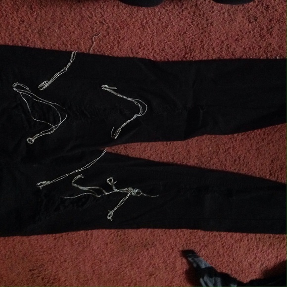 Ripped black skinny jeans with chains