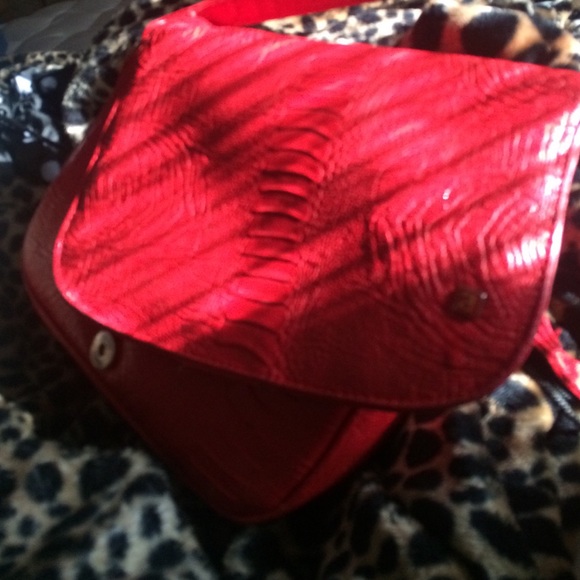 A red long strapped 6 pocket purse.