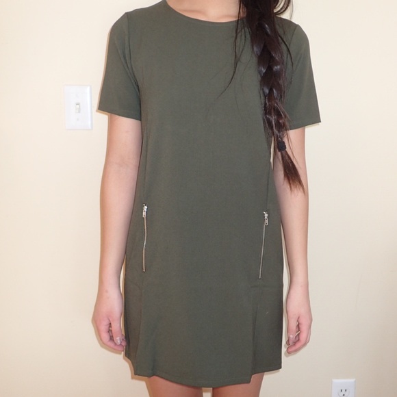 Modern olive shift dress with zipper details.