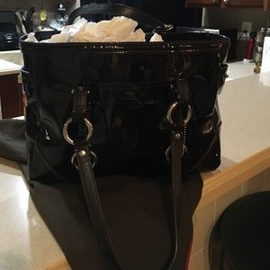 A black patent leather coach purse