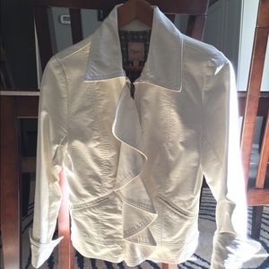 White faux leather jacket with ruffle detail.