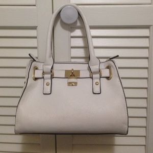 Small white purse with gold accents