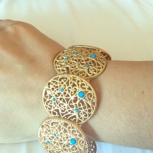 Gold colored bracelet with turquoise beads