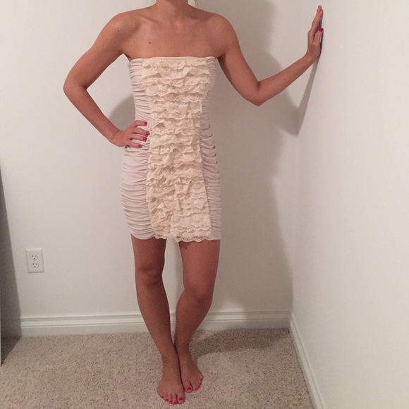 Ivory form fitting dress with front Ruffles.