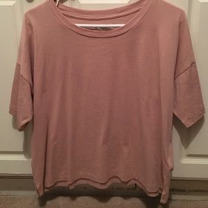 T shirt in peach color .