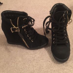 Black suede wedged sneaker with gold accents