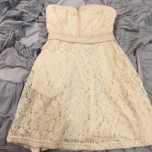 Cream lace strapless mini dress with pink detail