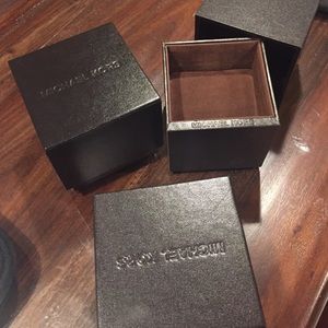 Three Michael Kors Watch Cases