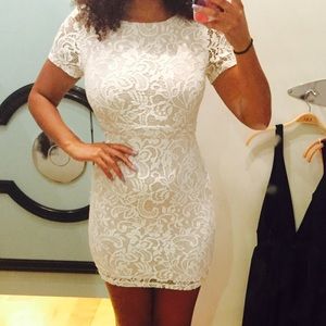 White lace dress with open back.