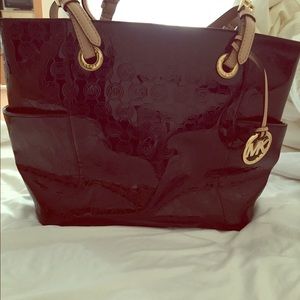 Michael Kors black patent leather handbag .