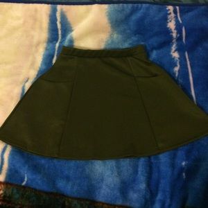 An olive skirt with pockets on each side.