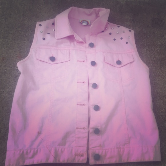 A pink vest with Golden brown spikes on the arms