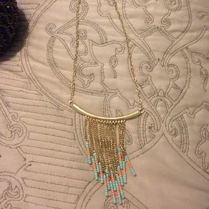 A gold with turquoise and peach necklace