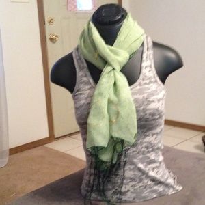 Green boho scarf with gold detail and fringe.