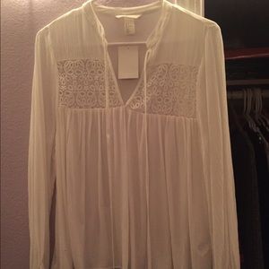 H&M, all white flowy shirt.