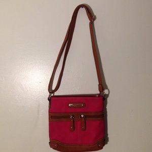 This is a pink and brown across shoulder bag.