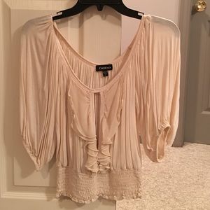 Bebe blouse with 3/4 sleeves and gathered waist.