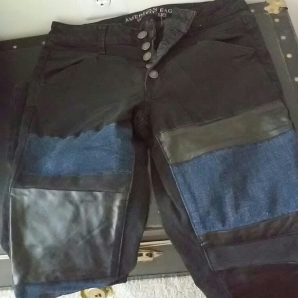 Black and blue denim jeans with faux leather panel