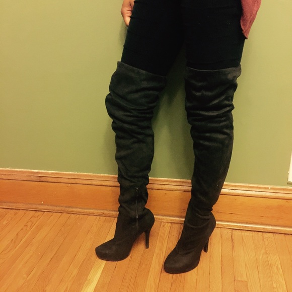Off black suede thigh high boots .