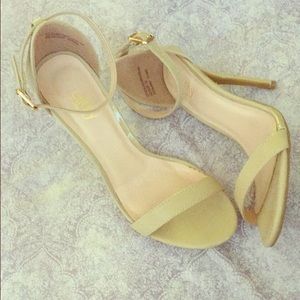 Nude strappy patent heels.