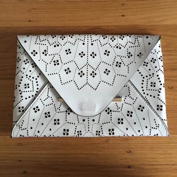 BCBG white lasercut clutch