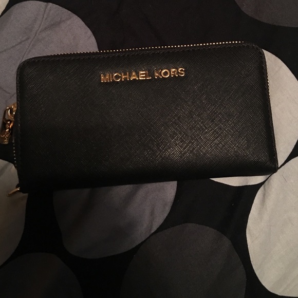 Michael Kors wallet black with gold trimming.