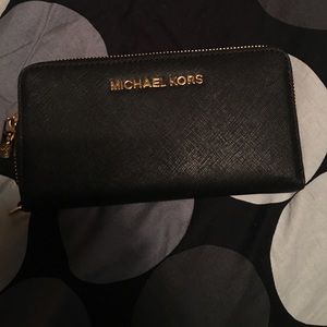 Michael Kors wallet black with gold trimming.