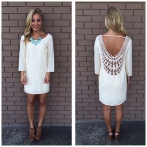 Cream embroidered low back shift dress.