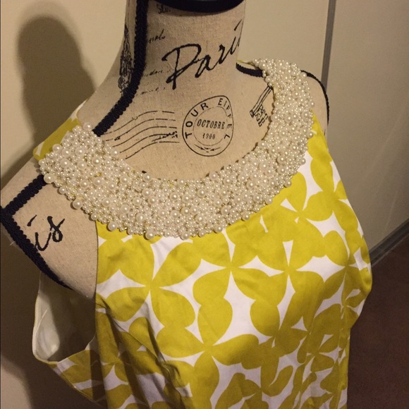 INC  dress with neckline adorned with pearls.