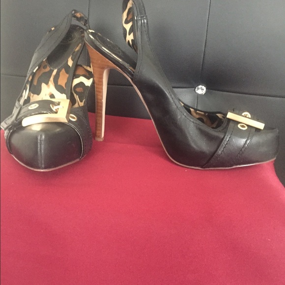 Black heels with a gold buckle