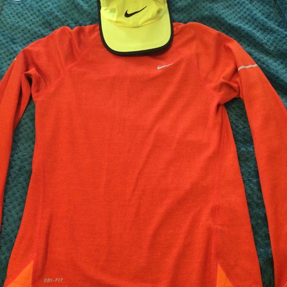 Orange long sleeve shirt with green Nike hat