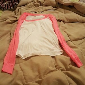 A  orange sleeve Victoria pink long sleeve shirt