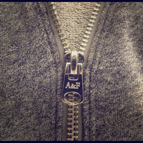 Light zip-up hoodie, grey w/ white stripes.
