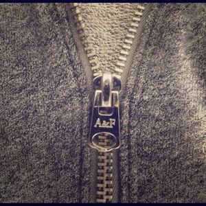 Light zip-up hoodie, grey w/ white stripes.