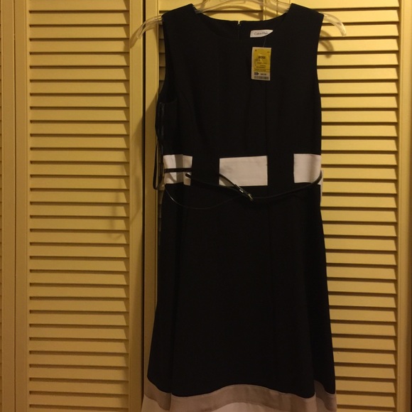 Black dress with a white stripe waist with a belt.