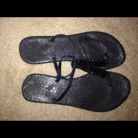 Black glittery flip flops