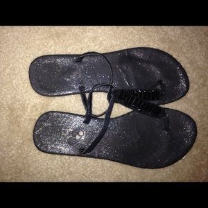Black glittery flip flops
