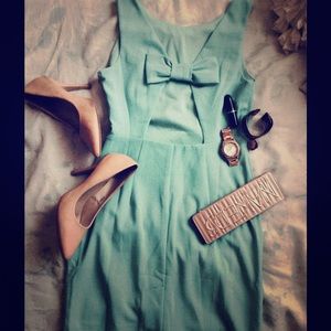 Bow open back teal dress.